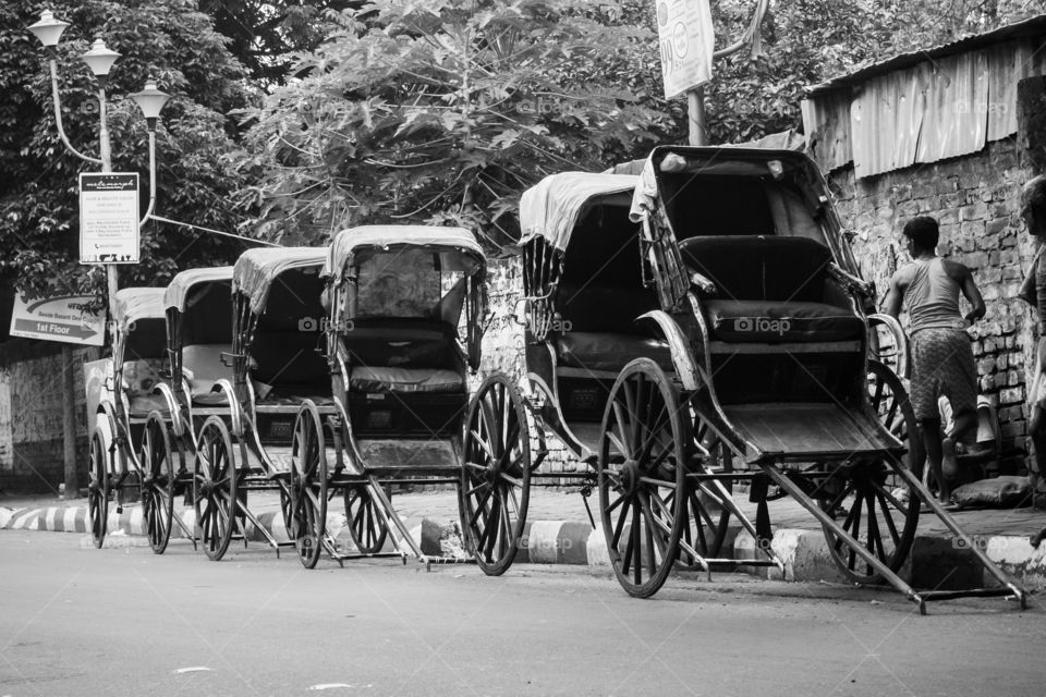 A pulled rickshaw is a mode of human-powered transport by which a runner draws a two-wheeled cart which seats one or two people.