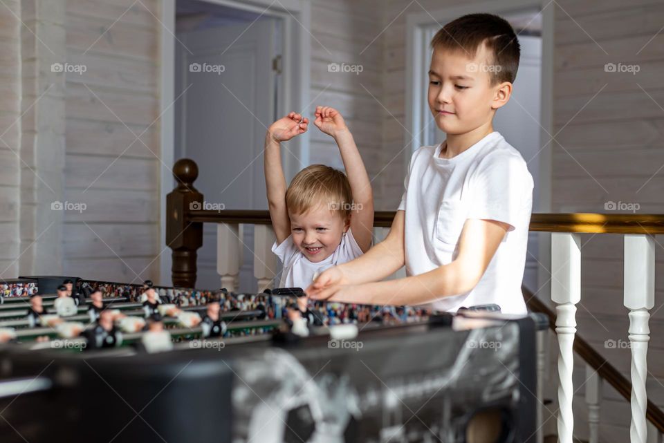 brothers playing table football