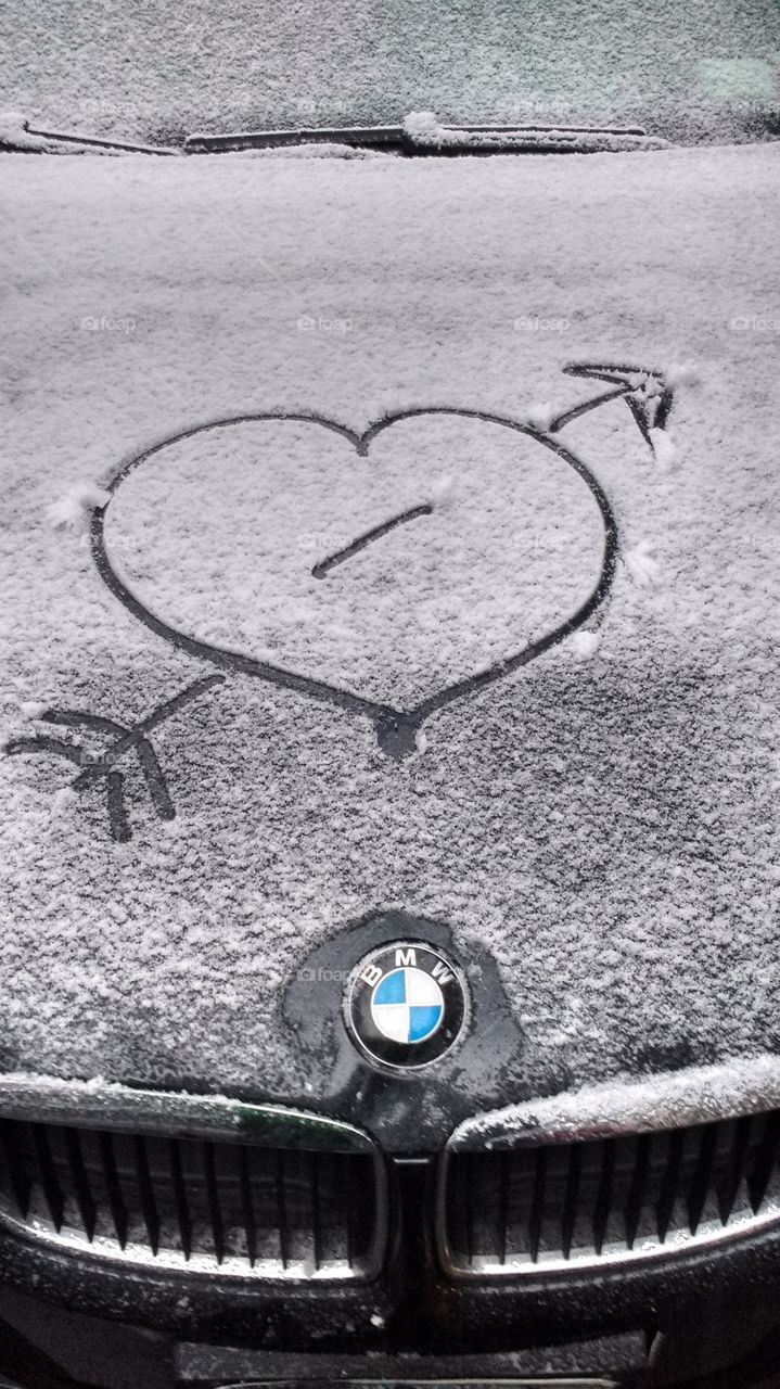 Snow Heart with Arrow through it on a Car