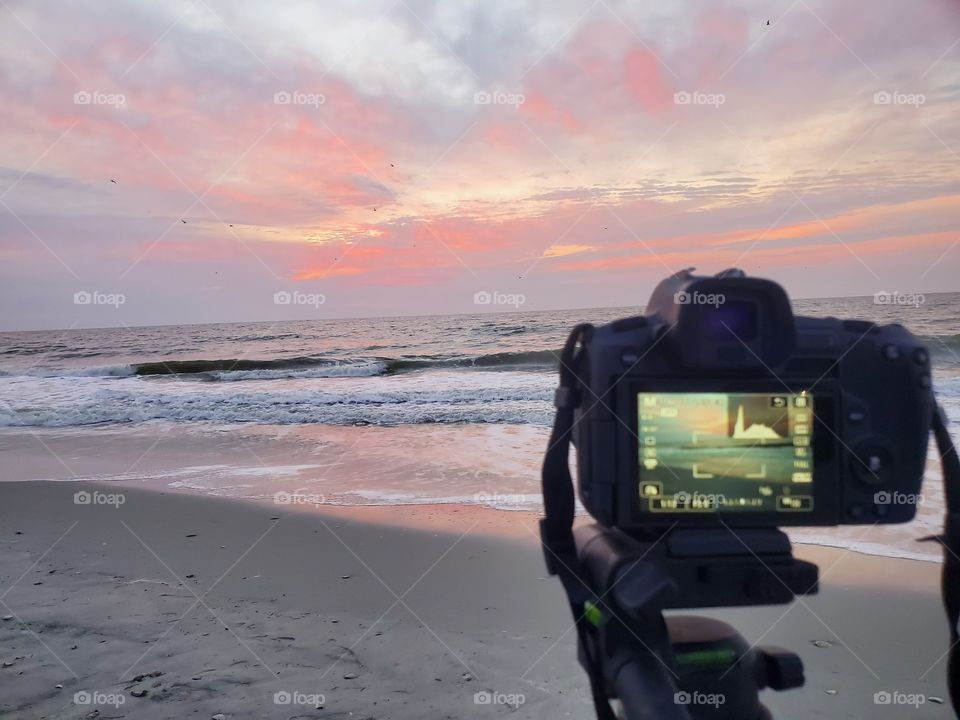 Getting the perfect shot of the sunrise on the beach.