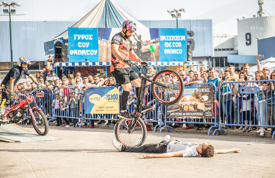 Doing Acrobatics With Bicycle In Front Of Crowd
