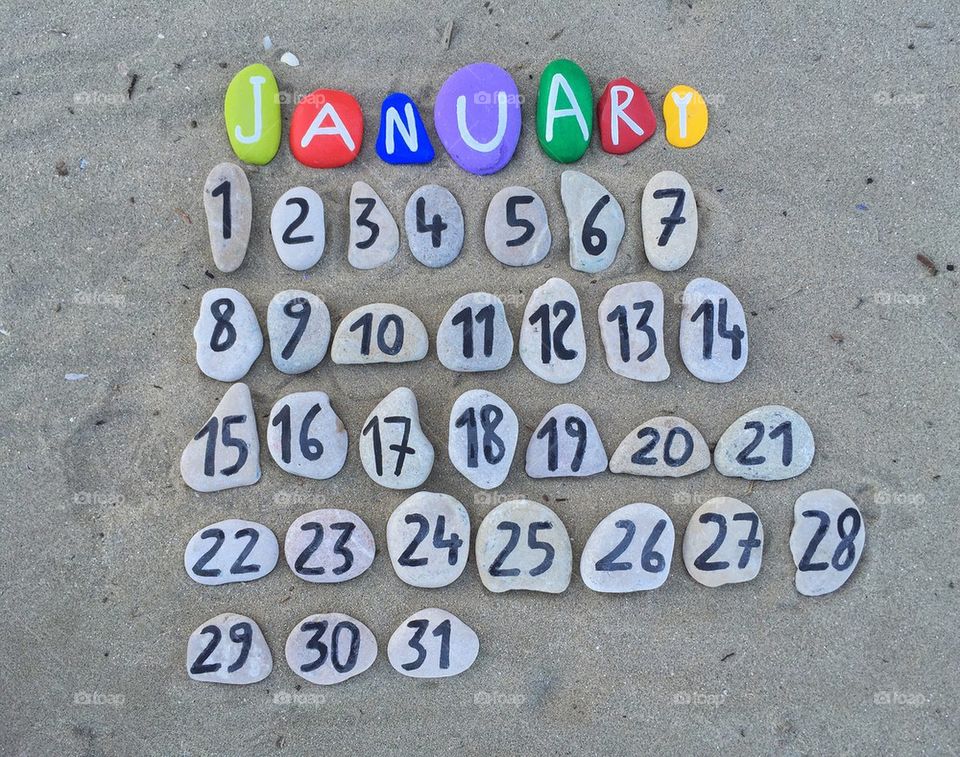 January, stones calendar on the sand