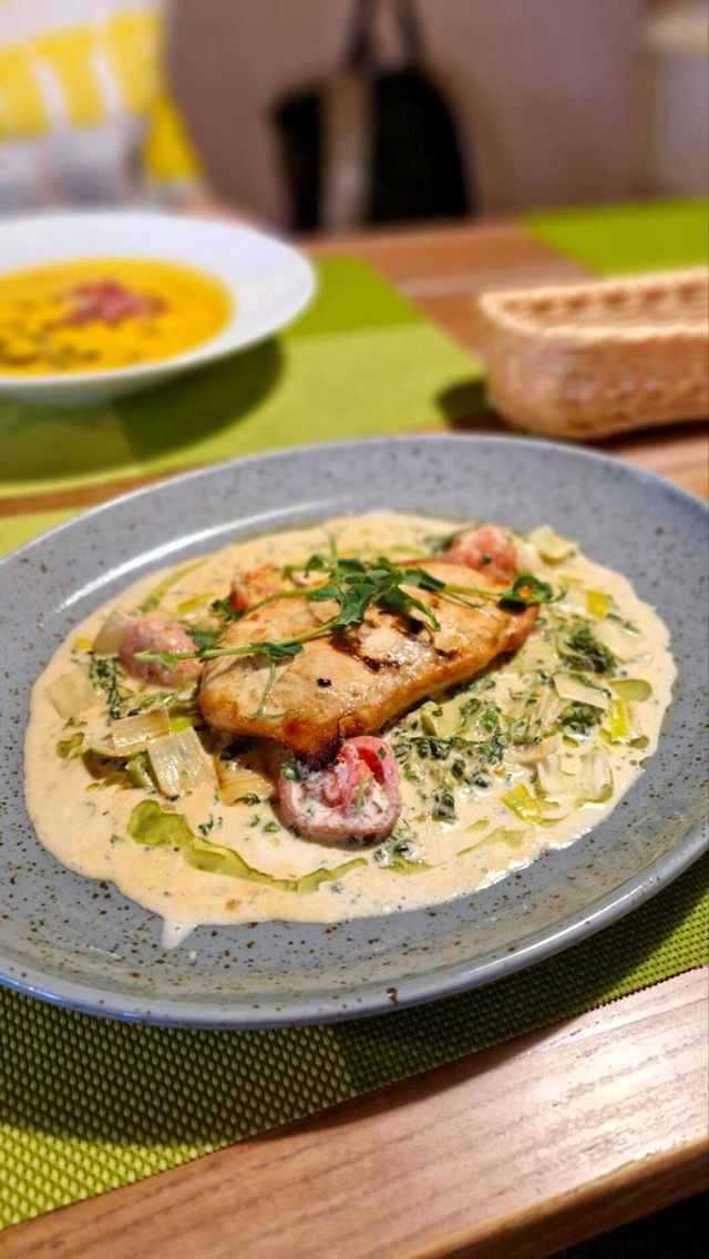 a dish with meat, vegetables and sauce