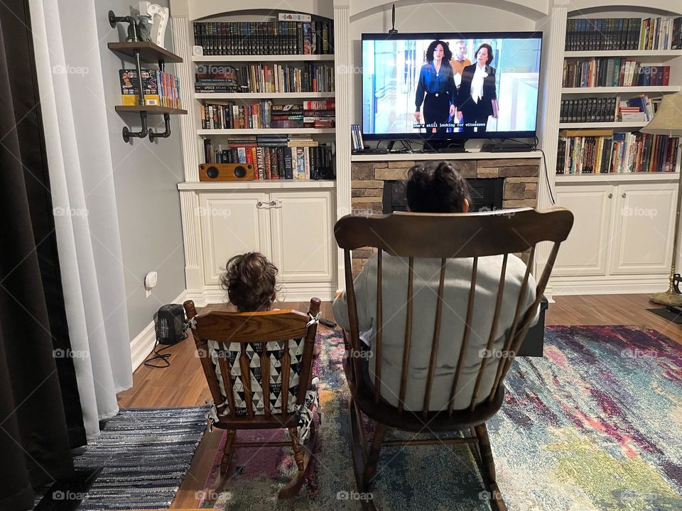 Mommy and toddler watching movie together in rocking chairs, mother and toddler watching movie, mother and toddler rocking in rocking chairs who or watching a movie, like mother like daughter, watching TV together as a family, toddler copy cat 