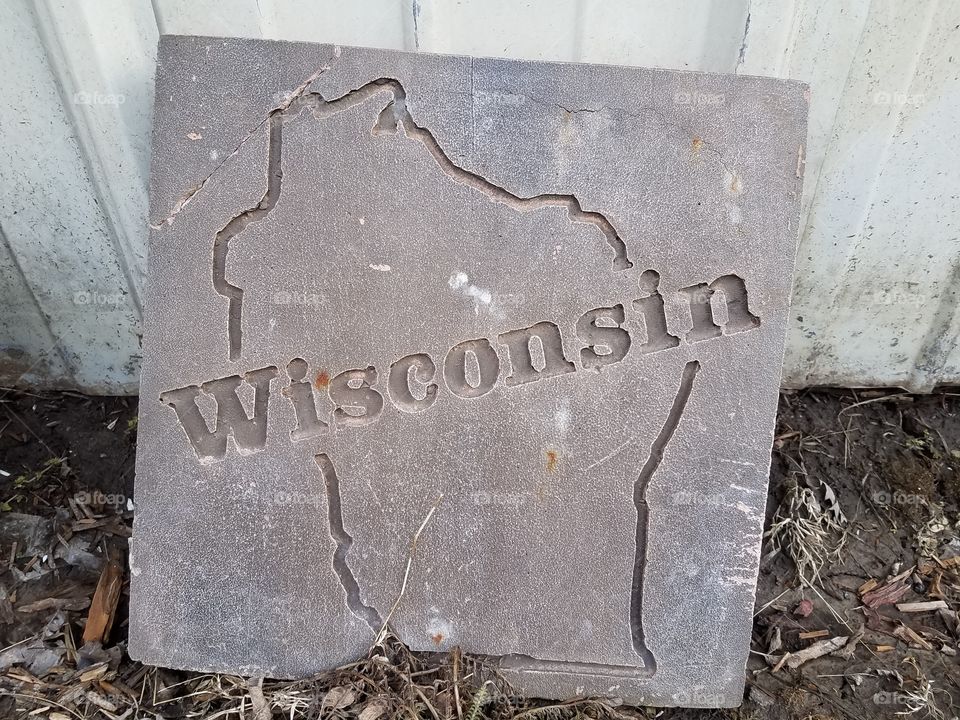 Wisconsin word text on abandoned tile