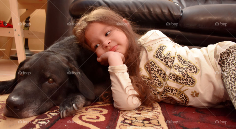 Girl leaning on dog's body