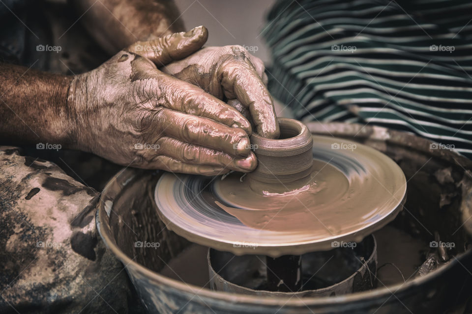 Pottery, working with a clay, hands in frame