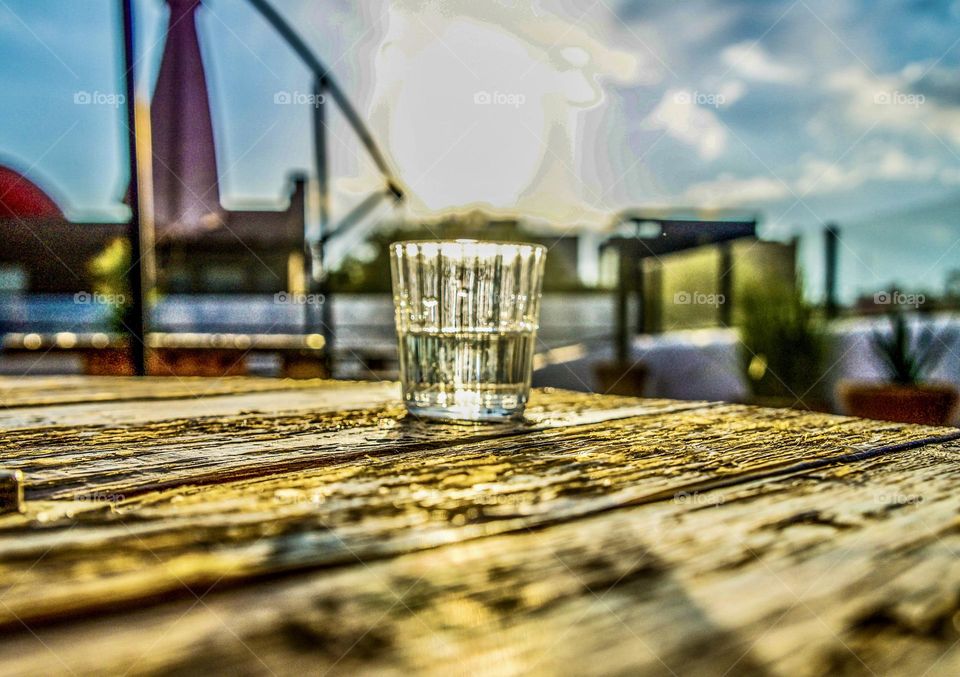 The sun floating over a glass of Mezcal.