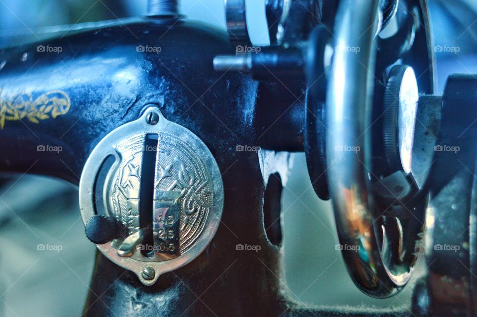 an old mechanical sewing machine made of cast iron with beautiful chrome details with patterns.