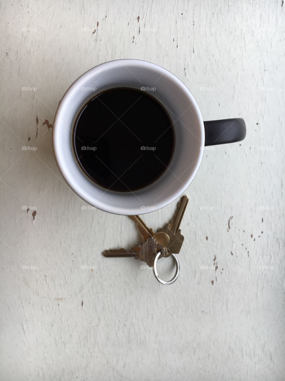 Cup of Coffee and Keys on a Antique White Desk in February 2018