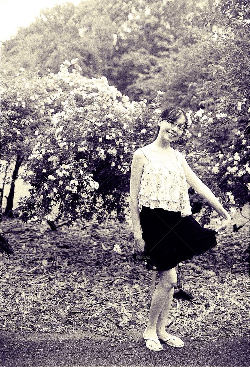 Lady in front of flowers