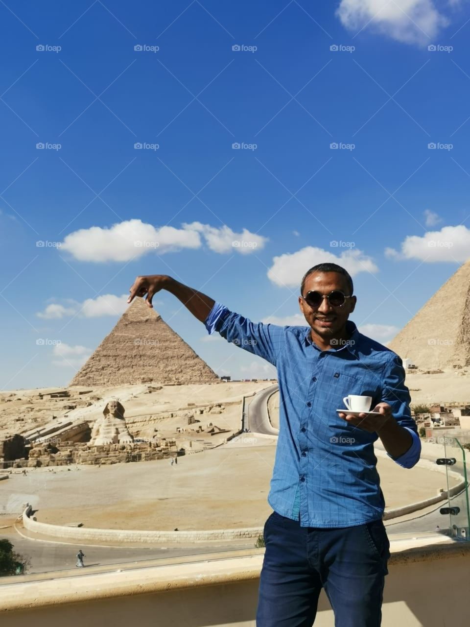 me enjoying cup of coffee on the Great Giza Pyramids view . Egypt