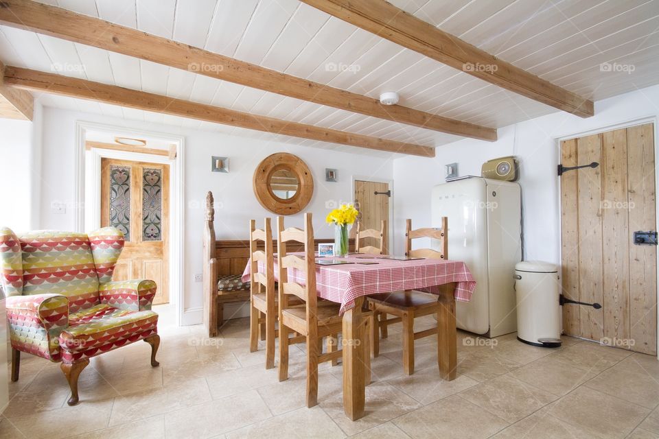 English Country Kitchen. A lightly lit English Country Cottage Kitchen with table and chairs.