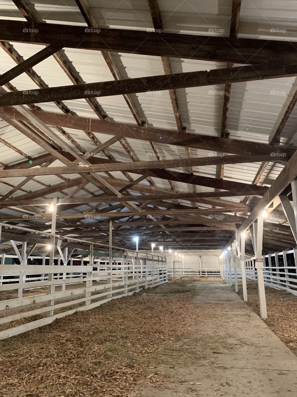 Empty stalls of an open-air barn for cattle before they’re shown in competition at a county fair