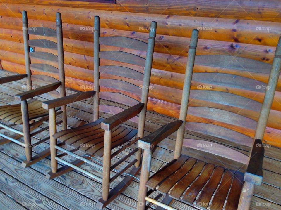 Rocking Chairs . A trio of vintage rocking chairs on a porch at a cabin in Wheresville TN.