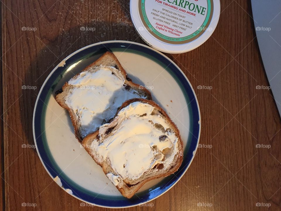 Cinnamon raisin bread toasted, spread with  mascarpone cheese. Delicious! Unfiltered picture. Can crop right side out for full grain background. 