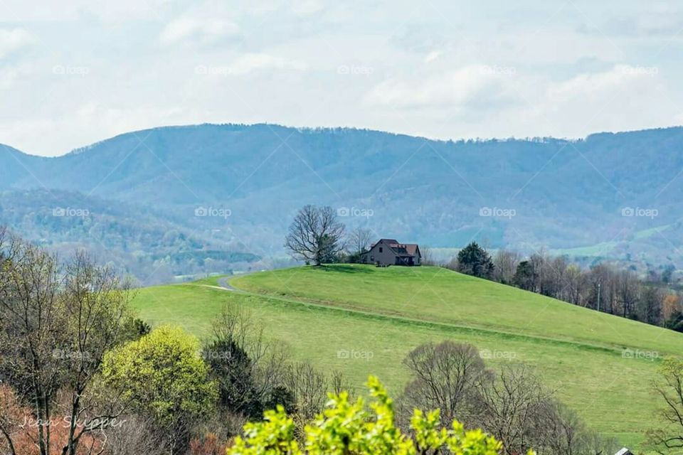 Landscape of house on hill and farmland