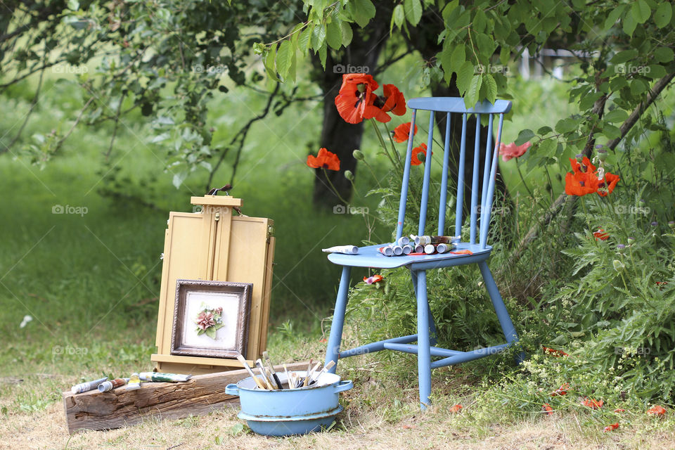 red poppy, blue chair and 
 painting
