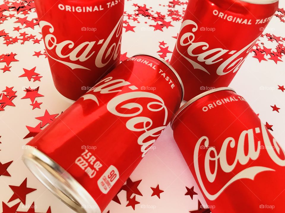 Coca Cola on a white background with red stars