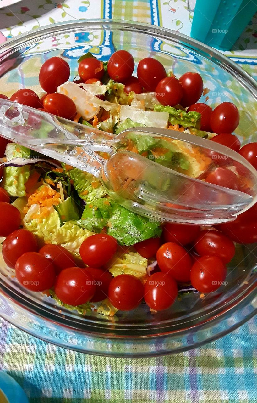 Fresh Garden Salad In Glass Bowl With Tongs