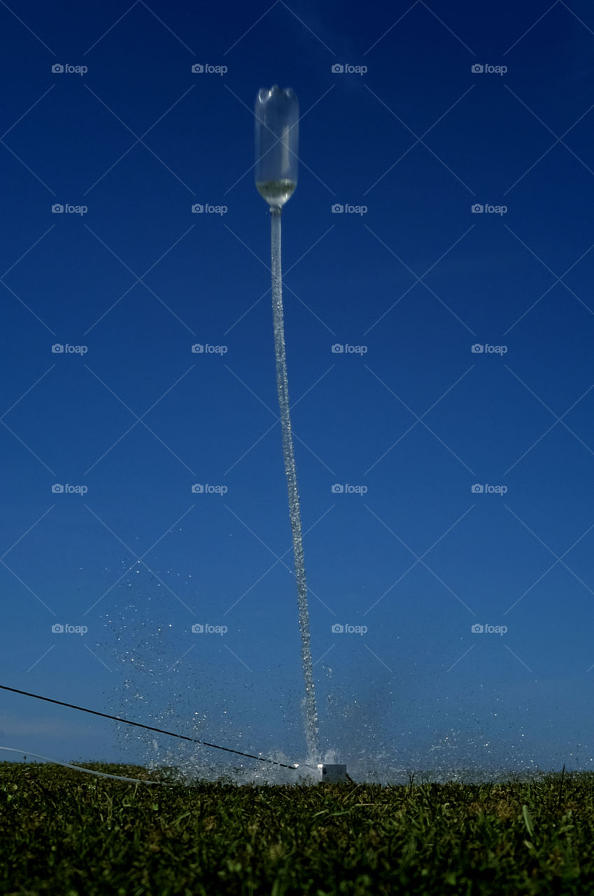 A water bottle rocket in mid launch as to blasts way up into the sky in Arapahoe North Carolina.