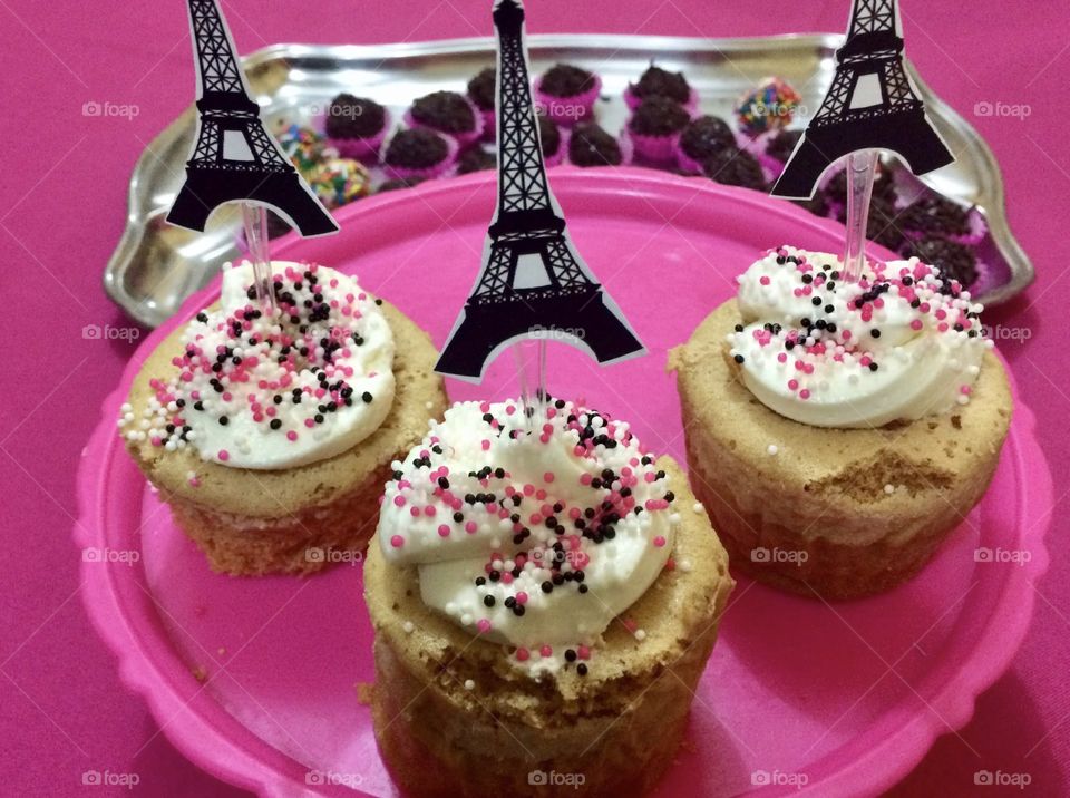 colorful muffins on pink background