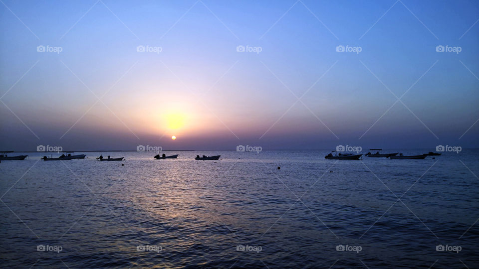 Local fishermen boats in in sunrise