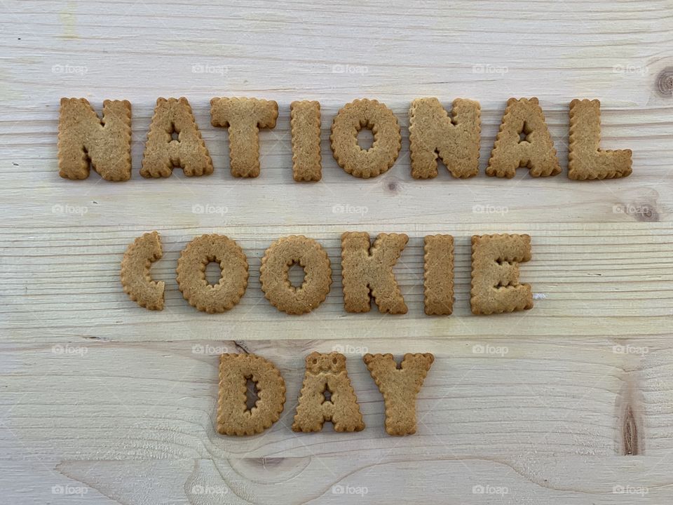 National Cookie Day Sign composed with cookie letters over wooden board