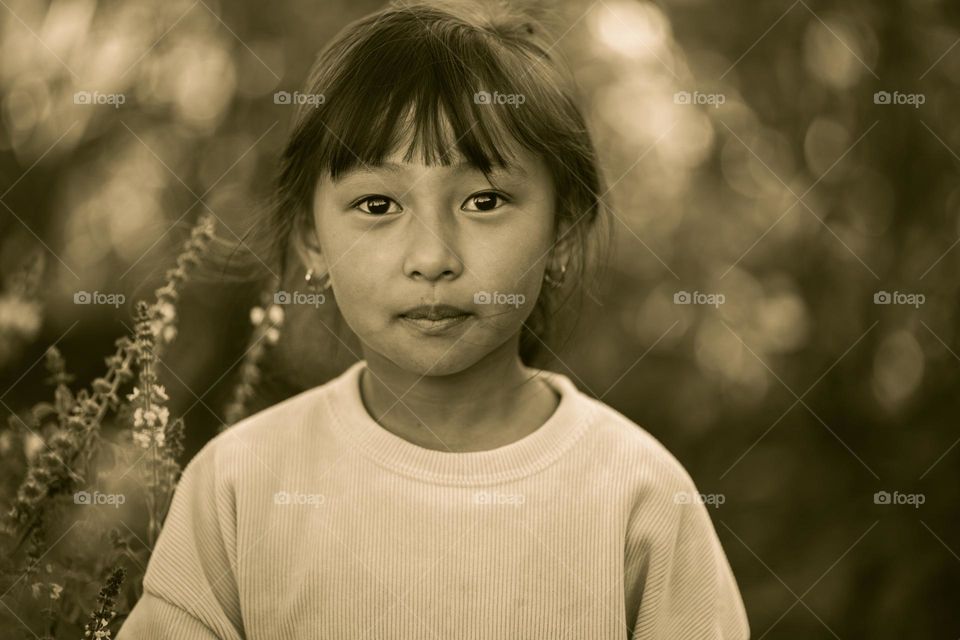 A vintage style portrait photography of a young little girl.