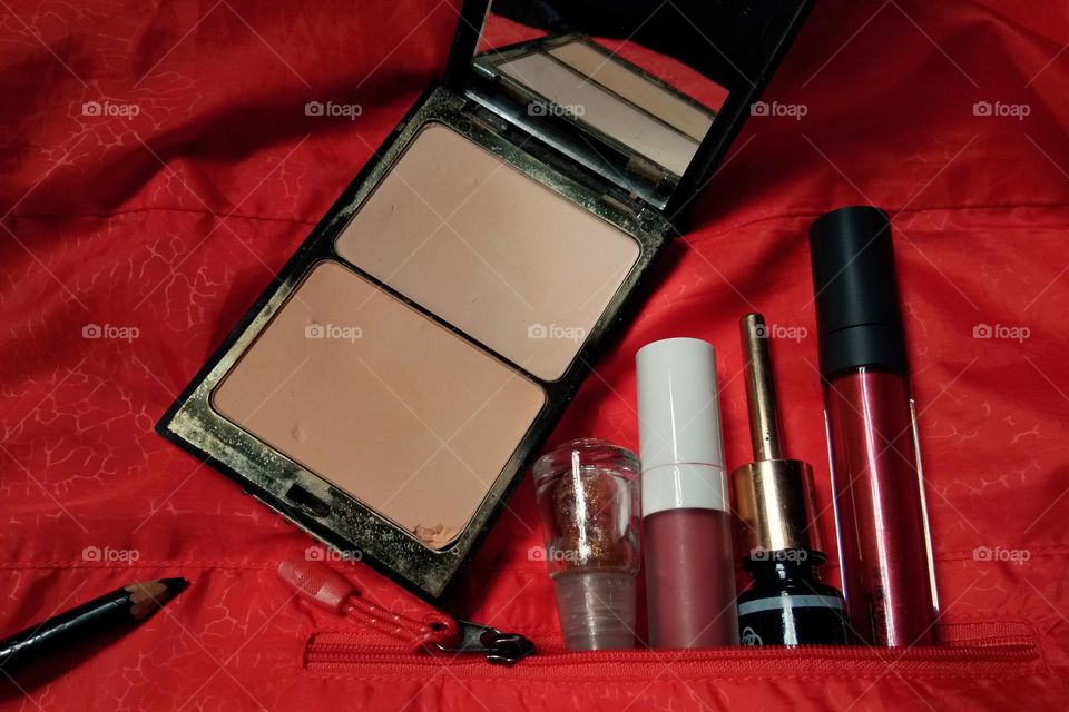 makeup products on crumpled fabric