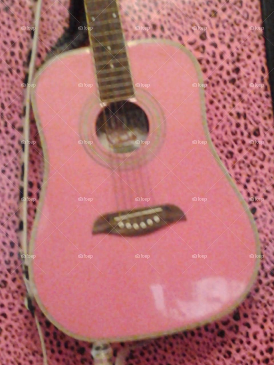 my guitar. my pink guitar on my pink leopard wall 