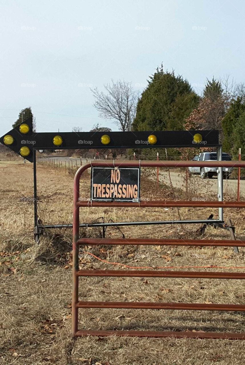 a light up 'this way' sign being a 'no trespassing' sign