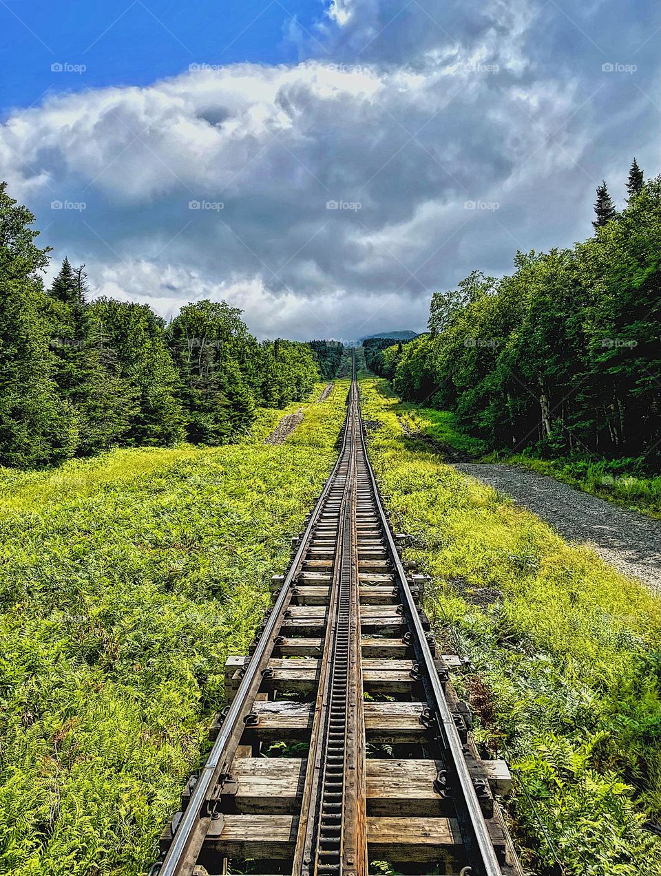 Into the mountains on a train track, going up the train tracks, the mountain climb in the train