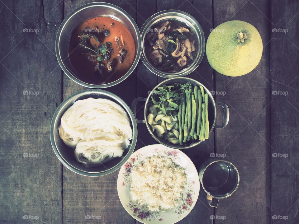thai food top view,vintage food , rice curry vagetable on wood floor,wood table