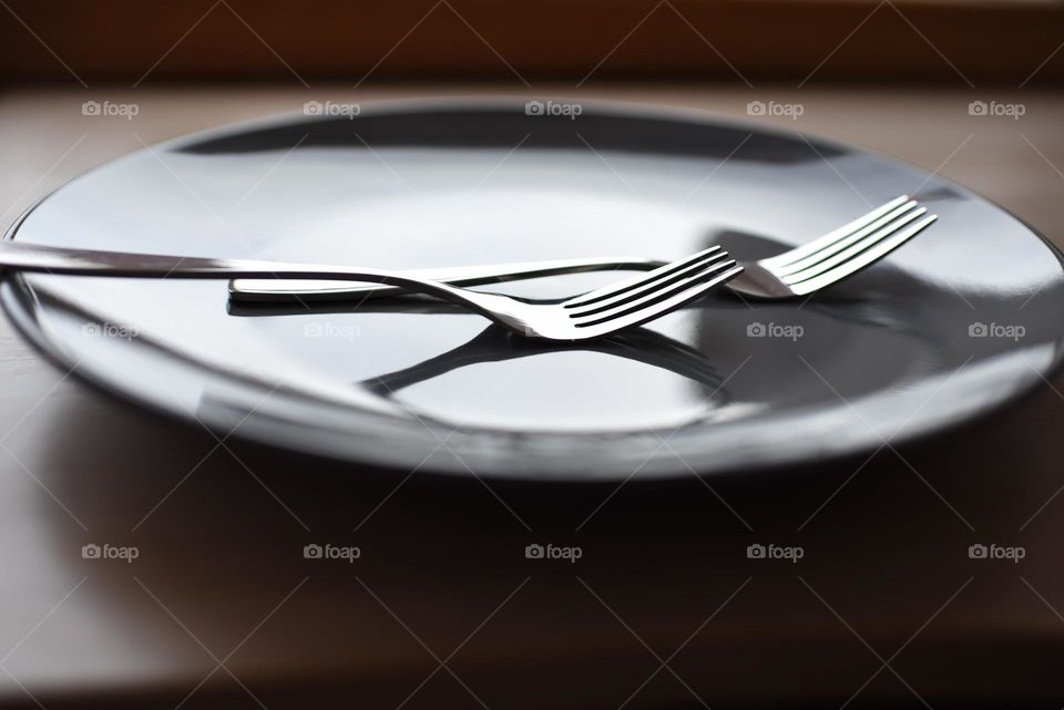 metal forks on a gray plate