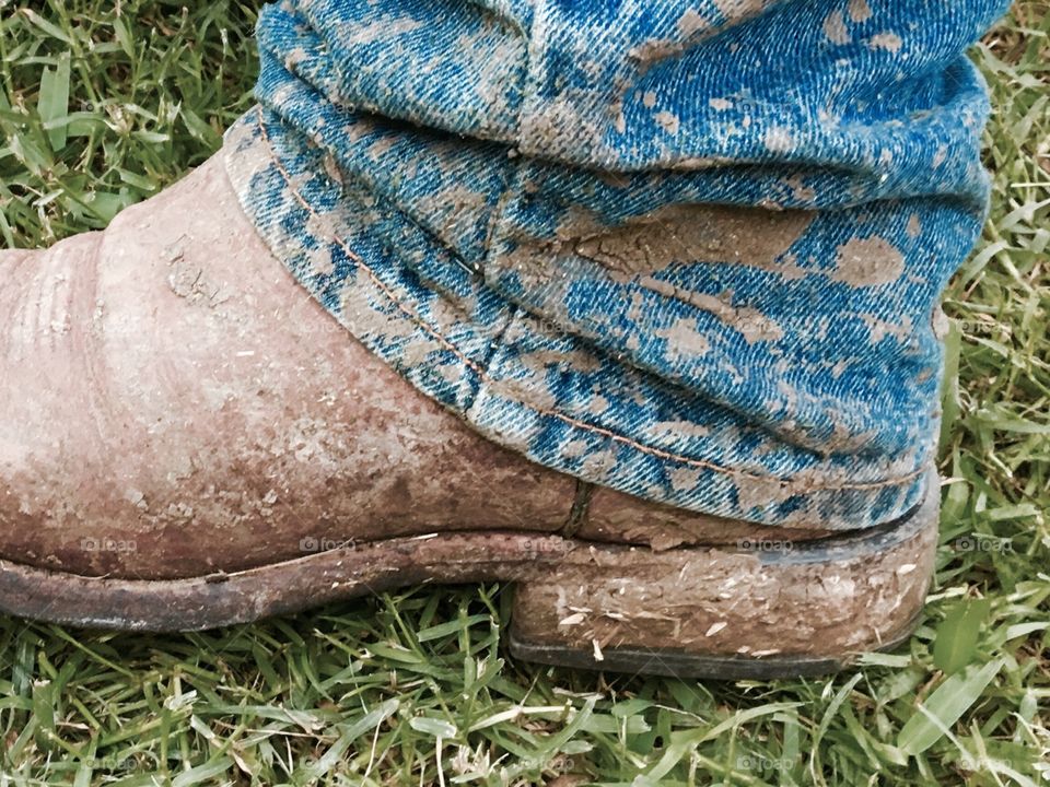 Muddy boot and jeans. 