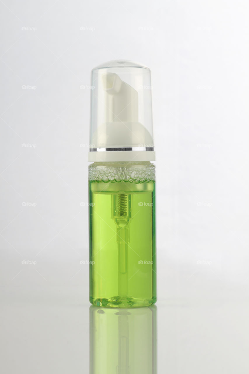 Green cosmetic product bottle for mockup