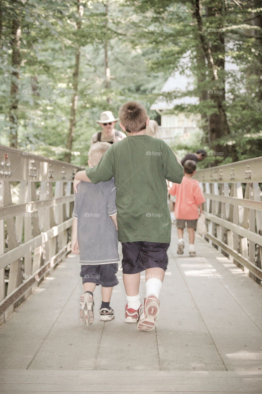 Big brother and little brother strolling on a Sunday afternoon