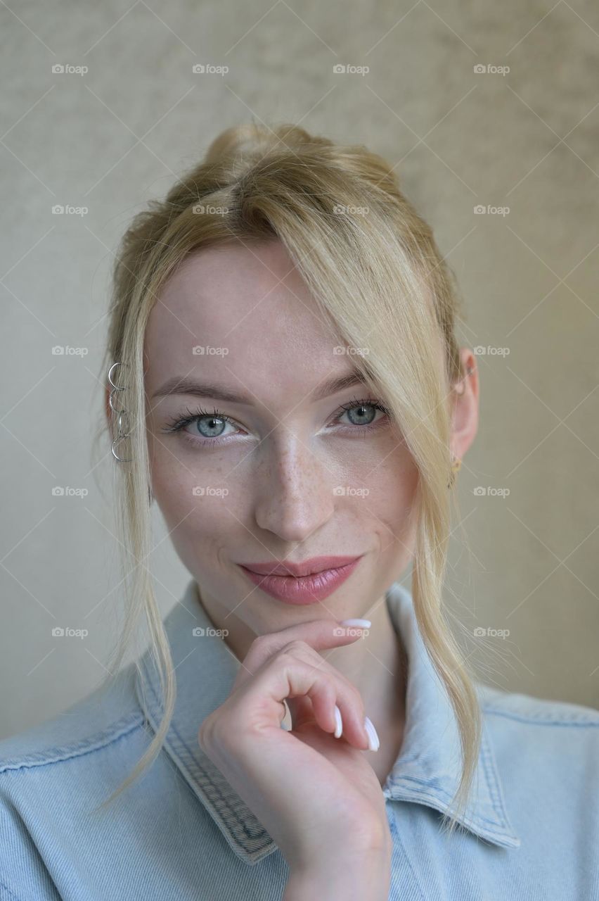 Portrait of a cute girl with blonde hair with a beautiful look