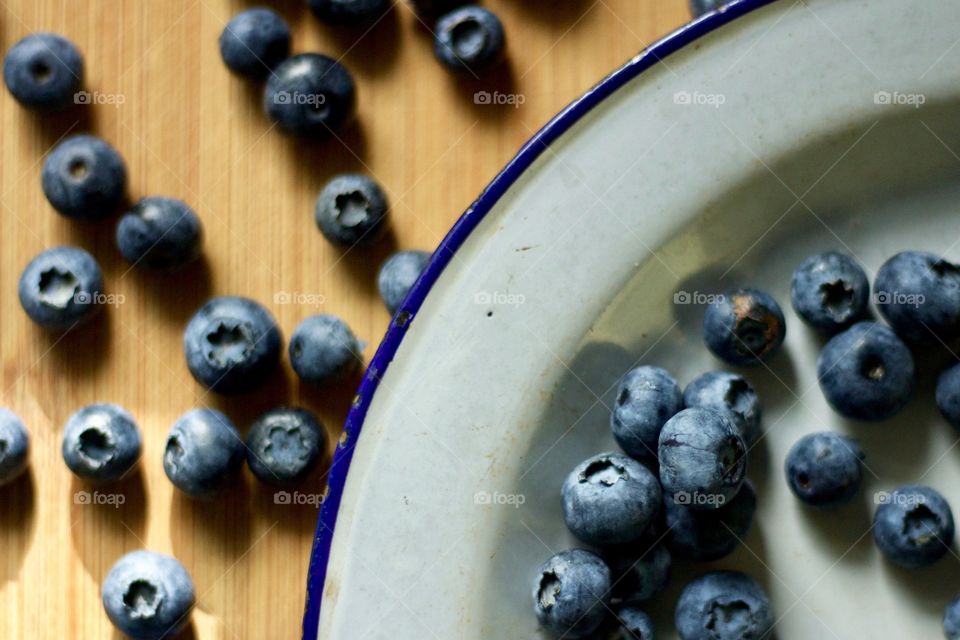 Fruits! - Blueberries on a vintage enamel plate on bamboo in natural light