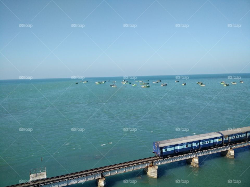 seaside train bridge and boats