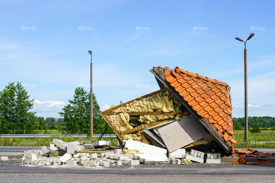 tiny house with tile roof turned over, ruined house