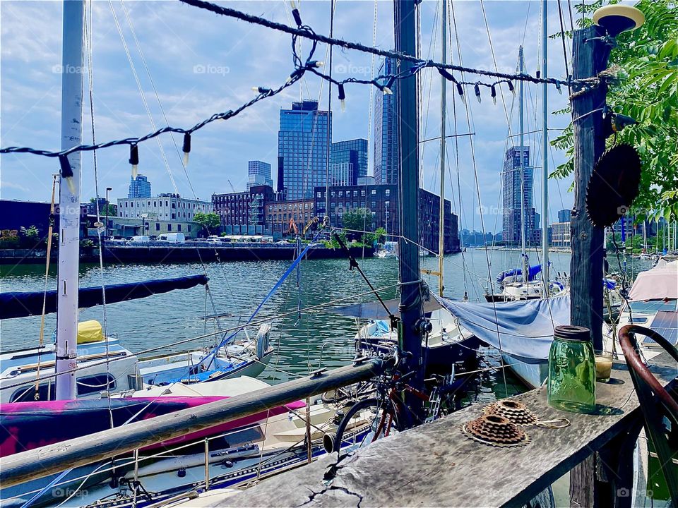 On this veranda at “Newtown Creek” in LIC, Queens parties, barbecues or get togethers are sometimes held. With the boats in the background and long strings with lights that are currently not lit it makes a beautiful motif. 2023. Hypnotic Productions