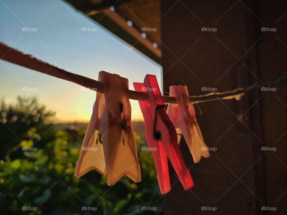 clothes pegs hanging on a rope
