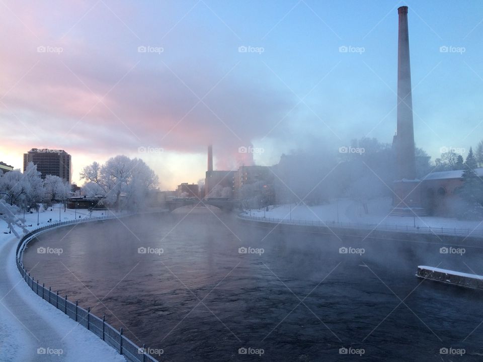 A cold morning in the city and water steaming from the river