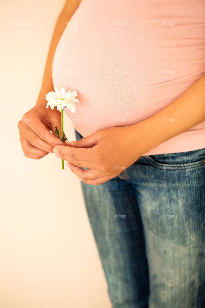 Pregnant woman holding flower
