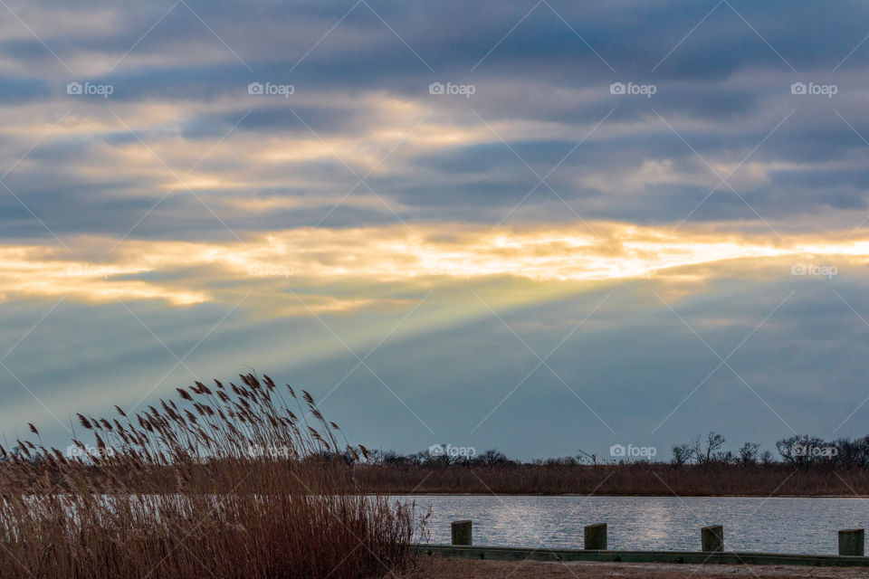 Sunbeams coming out of the clouds at sunset at the marina.
