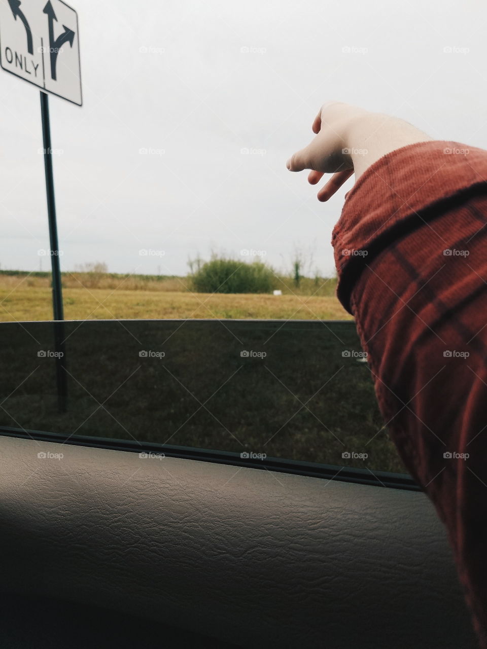 An arm outside of a window riding down a rural country road in the heart of Southern Ohio.