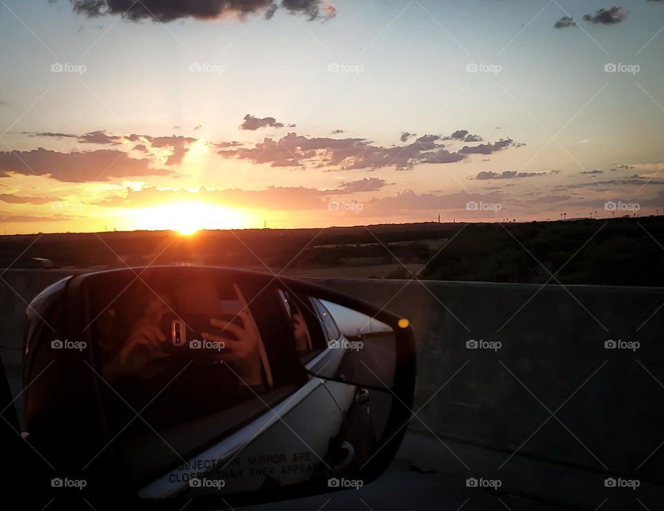 Capturing a beautiful sunset from a car.