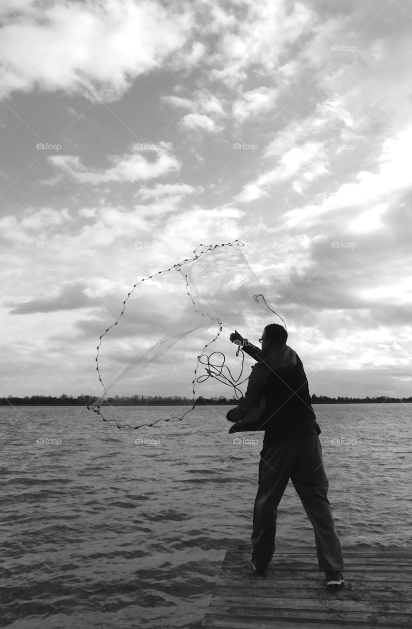 Happy Grey Story: A fisherman casts his net for the catch of the day! My Happy Grey Story photos shows cool, neutral, and balanced color which
communicates some of the strength and mystery of black!